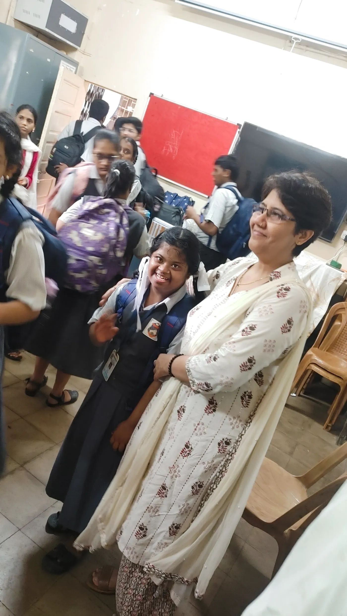 A HariKshama Foundation volunteer with a smiling student at the special school in Parel